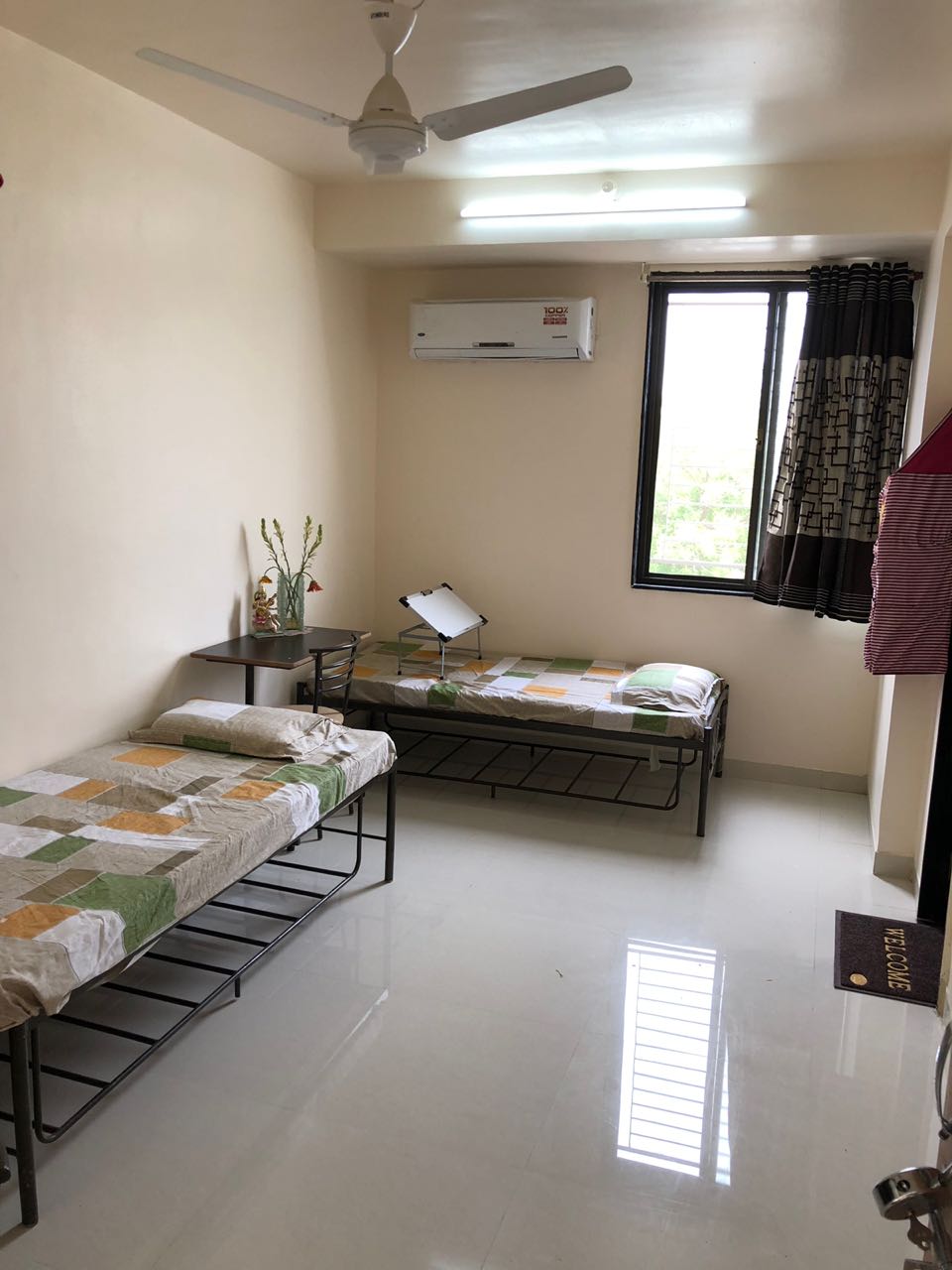 Photo of SDG Girls Hostel AC room with beds and window